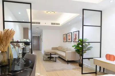 a living room with a couch and a table at Airy and Peaceful - Studio - JLT in Dubai