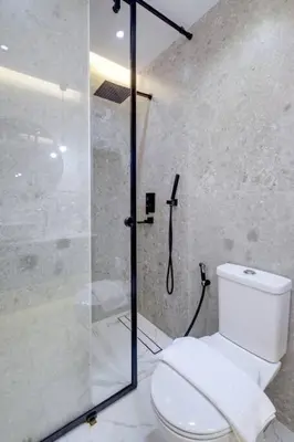 a bathroom with a toilet and a glass shower at Bright and cozy - Studio - JLT in Dubai