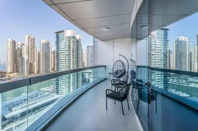 a balcony with chairs and a view of a city at Fully Furnished 4 BR in Dubai Marina - Very close to Metro in Dubai