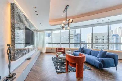 a living room with a blue couch and a large window at Fully Furnished 4 BR in Dubai Marina - Very close to Metro in Dubai
