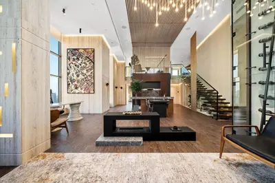 a living room with a table and a staircase at Luxury Duplex - 2 BR - Dubai Marina JBR in Dubai