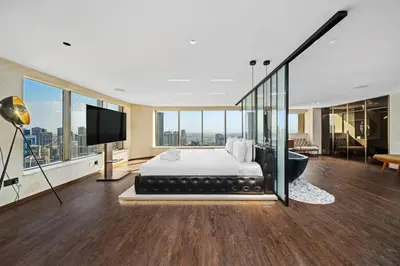 a bedroom with a bed and a tv and a tub at Luxury Duplex - 2 BR - Dubai Marina JBR in Dubai