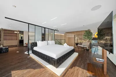 a bedroom with a large bed and a dining room at Luxury Duplex - 2 BR - Dubai Marina JBR in Dubai