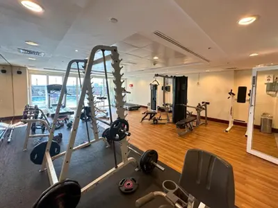 a gym with several treadmills and machines in a room at Classy and Bright - Studio - JLT in Dubai
