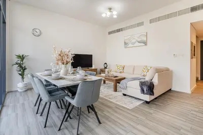 a living room with a table and a couch at Belgravia T2,JVC - 2BR Duplex Apartment - Allsopp&Allsopp in Dubai