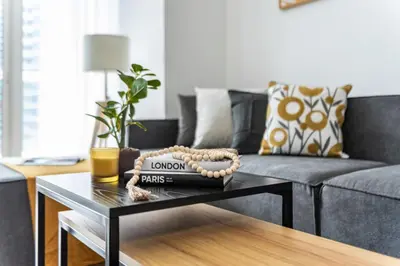 a living room with a couch and a coffee table at Lavish 2BR with Charming Marina View in Dubai