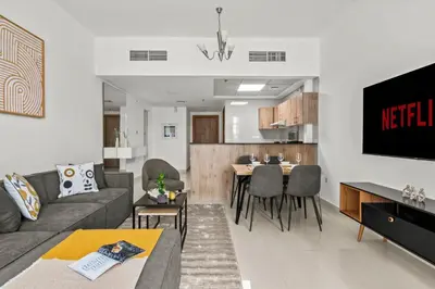 a living room with a couch and a table at Lavish 2BR with Charming Marina View in Dubai