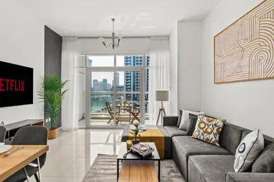 a living room with a couch and a table at Lavish 2BR with Charming Marina View in Dubai
