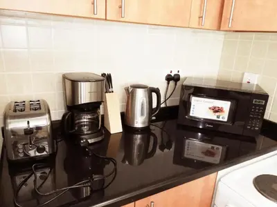 a kitchen counter with a coffee maker and a microwave at Spontaneous Sea View and High floor Studio Apartment in Dubai