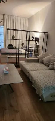 a bedroom with two beds and a table at A chilled place JVC in Dubai