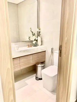 a bathroom with a toilet and a mirror at Dubai Galaxy in Azizi Riviera Luxury Studio in Dubai