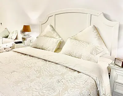 a white bed with white sheets and pillows at Dubai Galaxy in Azizi Riviera Luxury Studio in Dubai