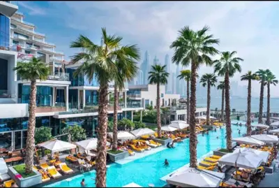 an image of a resort pool with palm trees at Five Palm Residences 2 Bedroom Apt in Dubai