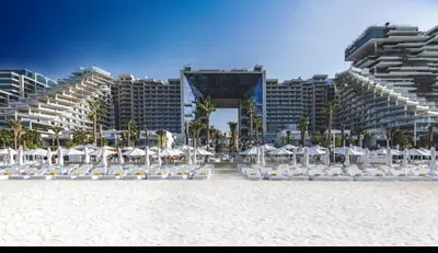 a group of chairs and umbrellas on a beach at Five Palm Residences 2 Bedroom Apt in Dubai