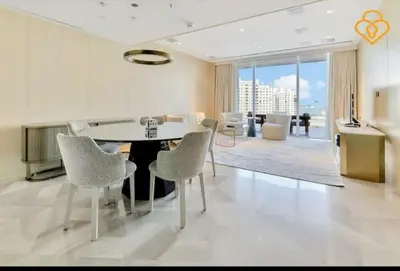 a dining room with a table and chairs at Five Palm Residences 2 Bedroom Apt in Dubai
