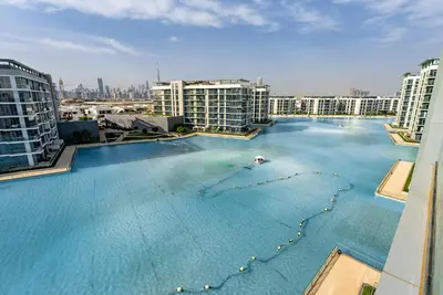 an overhead view of a large swimming pool with buildings at 3BDR with Maid Room I District One I Spacious and Cozy in Dubai