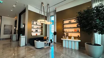 a lobby with a couch and a potted plant at Burj Crown Luxury 2bedroom Balcony & View in Dubai