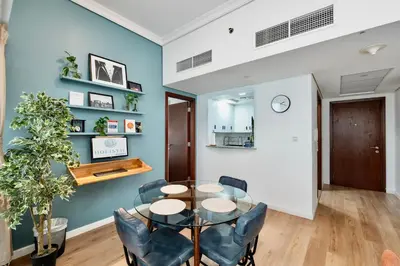 a dining room with a table and chairs at Next To Metro Unique 2bed Apt Wlarge Balcony in Dubai