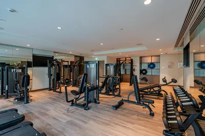a gym with several treadmills and exercise bikes at Brand New Luxurious 2BR ACT Towers Downtown in Dubai