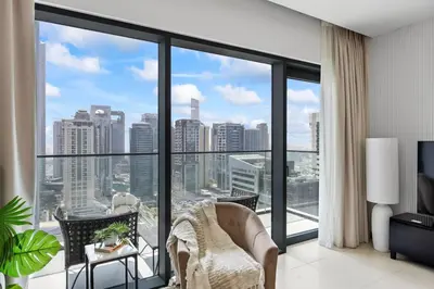 a living room with a view of a city at Hidden Gem, Waterfront Escape With Harbor View in Dubai