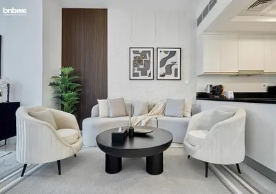 a living room with a couch and chairs and a table at bnbme - Premium 1BR Apt Balcony Pool Gym Parking Near Dubai Mall & Burj Khalifa in Dubai