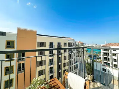 an apartment balcony with a view of buildings at HiGuests - Coastal Chic Luxurious Retreat at Port de la Mer in Dubai