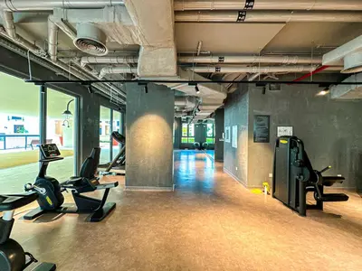 a gym with treadmills and exercise equipment in a building at HiGuests - Coastal Chic Luxurious Retreat at Port de la Mer in Dubai