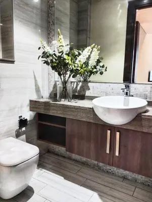 a bathroom with a sink and a toilet and flowers at Vacay Lettings 1 bed Business home in J One Tower Business bay in Dubai