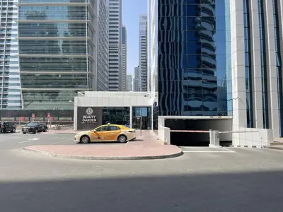 a yellow car parked in a parking lot in a city at Spacious Jlt High Floor Studio Wstunning Views in Dubai