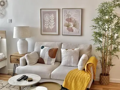 a living room with a couch and a table at Spacious Jlt High Floor Studio Wstunning Views in Dubai
