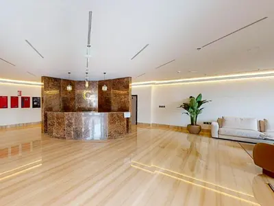 a living room with a couch and a table at HAVN - Studio Apartment in Chaimaa Avenue, JVC in Dubai