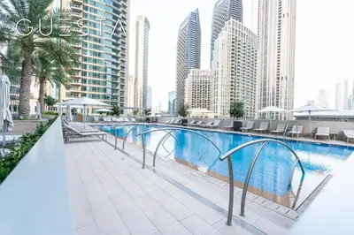 a swimming pool in the middle of a city with tall buildings at Forte Tower by Emaar, Downtown Dubai in Dubai