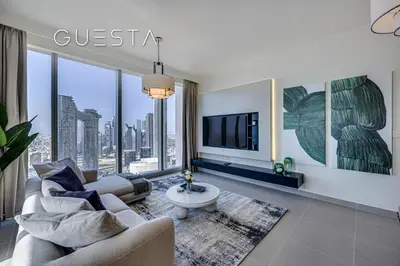 a living room with a couch and a tv at Forte Tower by Emaar, Downtown Dubai in Dubai