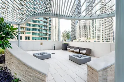 a rooftop patio with a view of skyscrapers at Forte Tower by Emaar, Downtown Dubai in Dubai