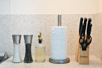 a kitchen counter with utensils and a container with a candle at Seascape Sanctuary - 3 and a Half BR Beachfront Bliss - Marina Vista Tower 1 in Dubai
