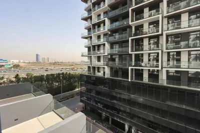a view from the balcony of a building at Chic 1BR in JVC with Balcony, Near Mall & Parks in Dubai