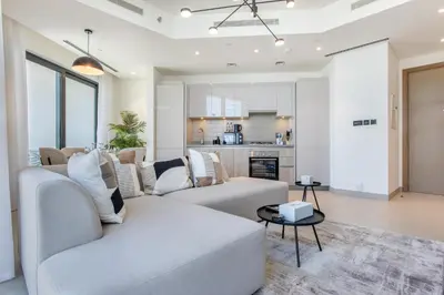 a living room with a couch and a table at STAY BY LATINEM Luxury 2BR Holiday Home W3104 near Burj Khalifa in Dubai