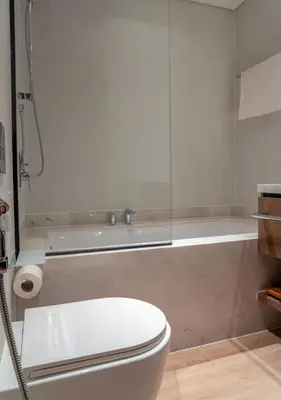 a bathroom with a toilet and a bath tub at Lux 1BR Apartment with Amazing view in Palace Residences Creek Harbor in Dubai