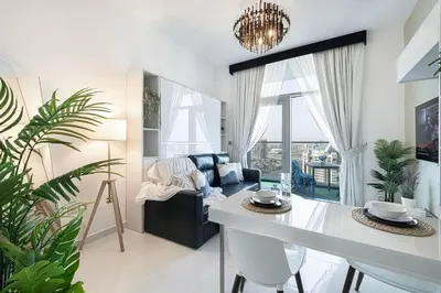 a living room with a couch and a table at Dubai Sleek & Cozy Space in Dubai