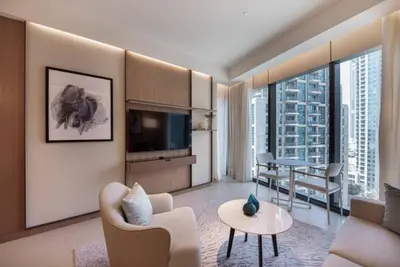a living room with a couch and a dining room at Luxurious stay in Downtown Dubai in Dubai