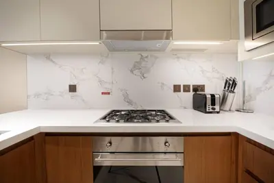 a kitchen with a stove and a white counter top at Luxurious stay in Downtown Dubai in Dubai