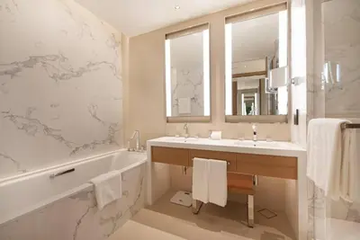 a bathroom with a tub and a sink and a mirror at Luxurious stay in Downtown Dubai in Dubai