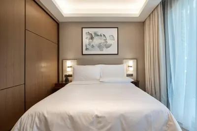 a bedroom with a large white bed and a window at Luxurious stay in Downtown Dubai in Dubai