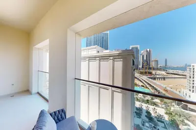a large balcony with a view of a city at Vida Residences at Creek Beach - Light Two Bedroom in Dubai