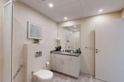 a bathroom with a toilet and a sink at MAG 218 Tower - Elegant One Bedroom in Dubai