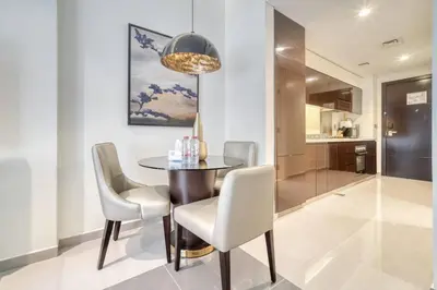 a dining room with a table and chairs at Dazzling Studio Apartment in Business Bay l City View in Dubai