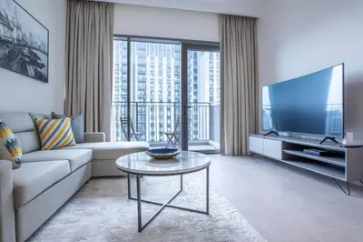 a living room with a couch and a tv at 1BR Apartment in Park Heights 2 Dubai Hills in Dubai
