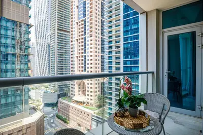 a balcony with a table and a view of a city at Spacious 1BR in the iconic Torch Tower, Dubai Marina - Allsopp&Allsopp in Dubai