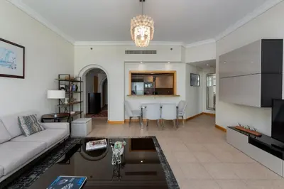 a living room with a couch and a table at Shoreline 7, Palm Jumeirah - Mint Stay in Dubai