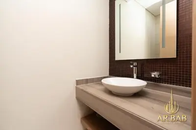 a bathroom with a sink and a mirror at Damac Paramount - Luxurious 2BR - Stunning Dubai Canal View - High Level in Dubai
